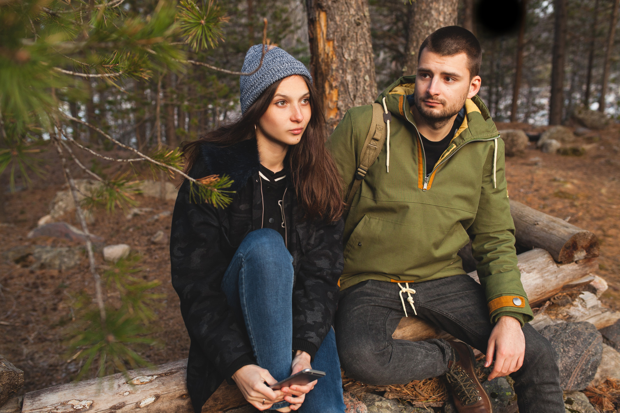 Diverse collection of premium outdoor clothing and gear from leading brands like Patagonia, The North Face, and Arc'teryx, featuring technical jackets, hiking boots, and backpacks against a mountain landscape backdrop. 